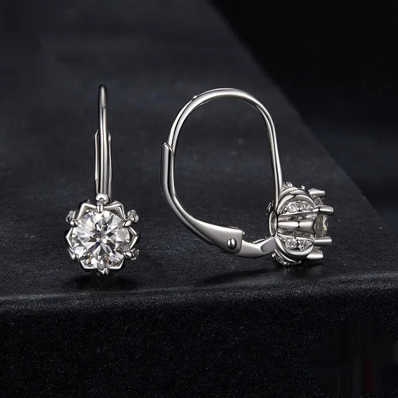 White gold plated sterling silver flower bud ear clip with a moissanite stone.