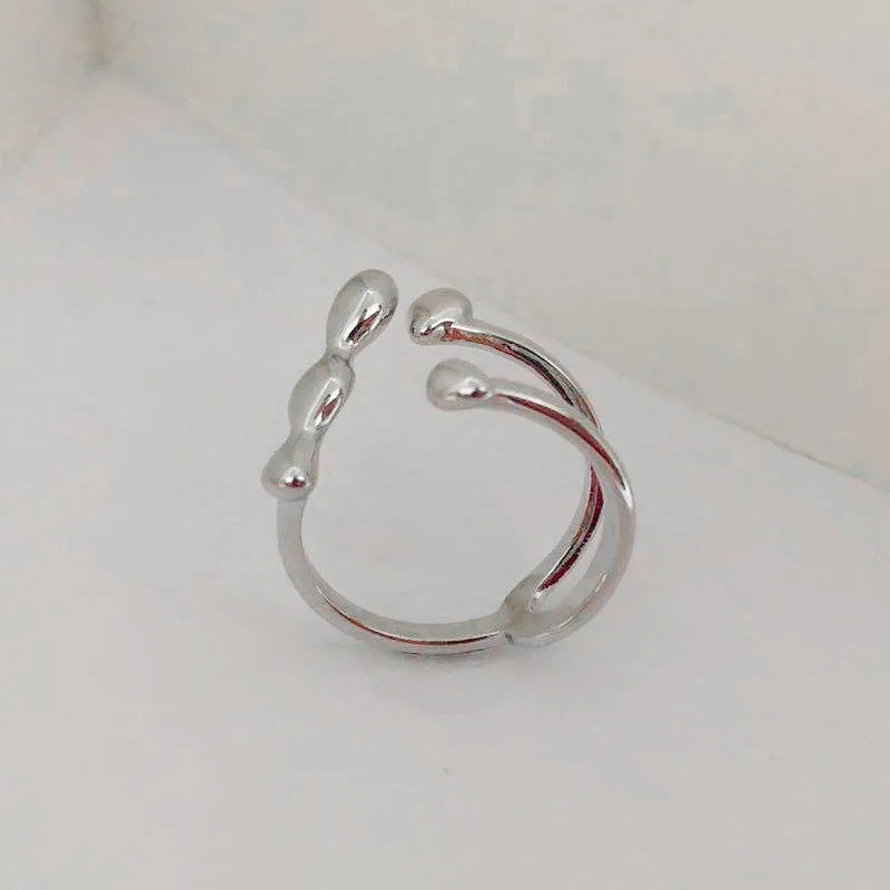Adjustable brass opening ring with spherical design in gold or silver colour
