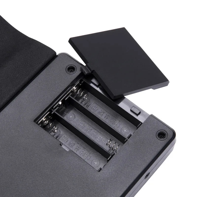 Glossy Black portable folding electronic keyboard with 49 silicone keys, shown both folded and unrolled.