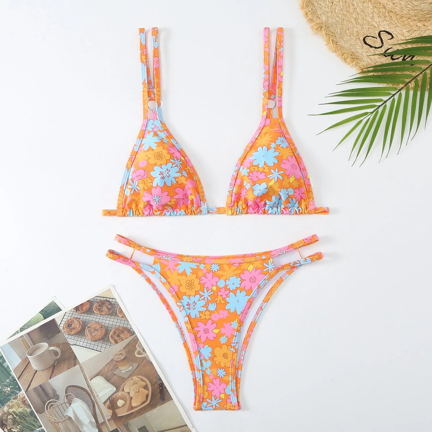 Women's blue halter-style swim briefs with a floral pattern, backless design.