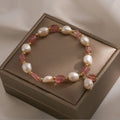 Adjustable strawberry quartz bracelet with Hetian jade peach blossom charm on wrist
