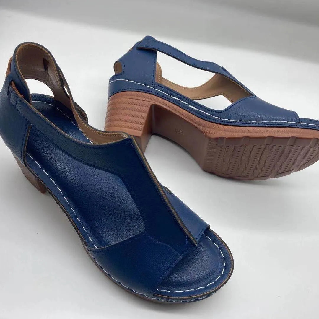 Plus size women's beige open toe wedge sandals with a buckle strap and low heel on a white background.