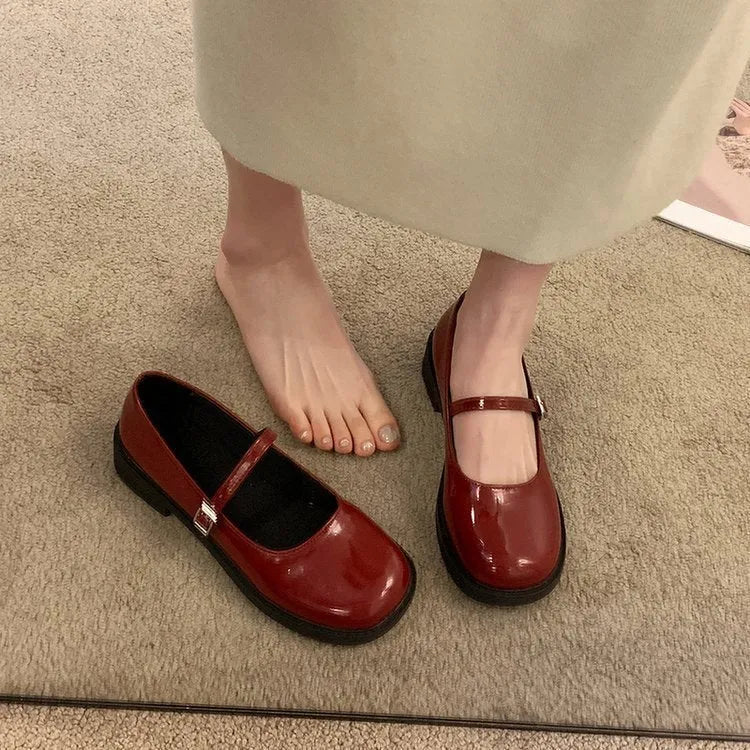 Women's solid colour flat heel loafers in red, black, or greyish black.