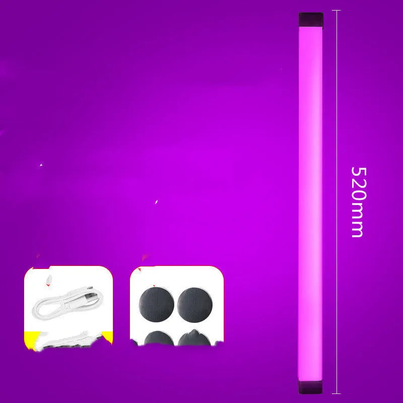 Blue and purple rechargeable LED tube light with USB cable on a dark background.