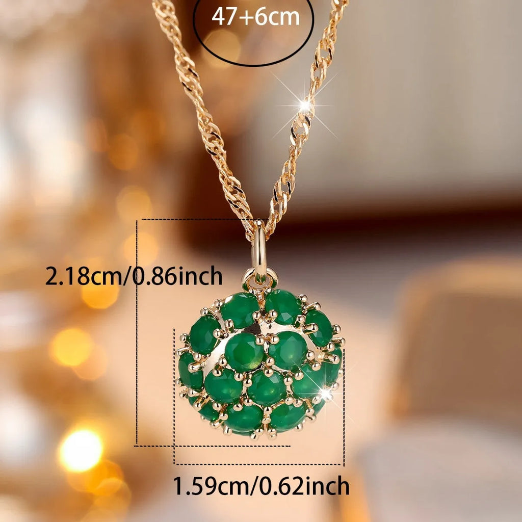 Women's champagne gold necklace with round emerald pendant and diamond accents on copper chain