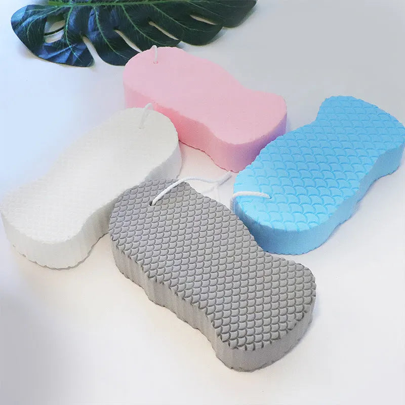 3D bath sponge ball with fish scale texture in white, grey, pink, and light blue colours