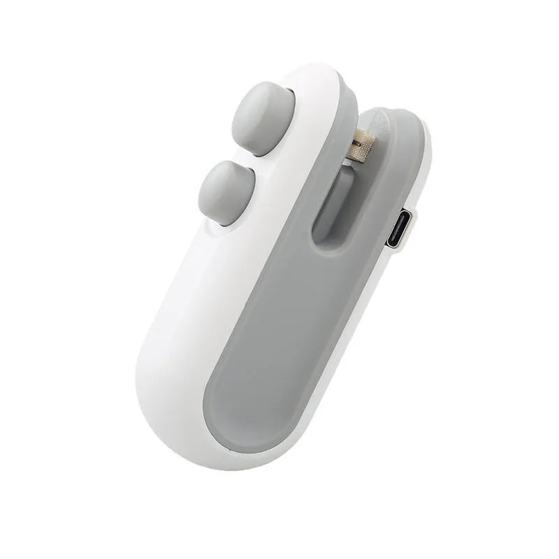 Blue and white handheld USB rechargeable food sealer with magnetic back and cutter blade.