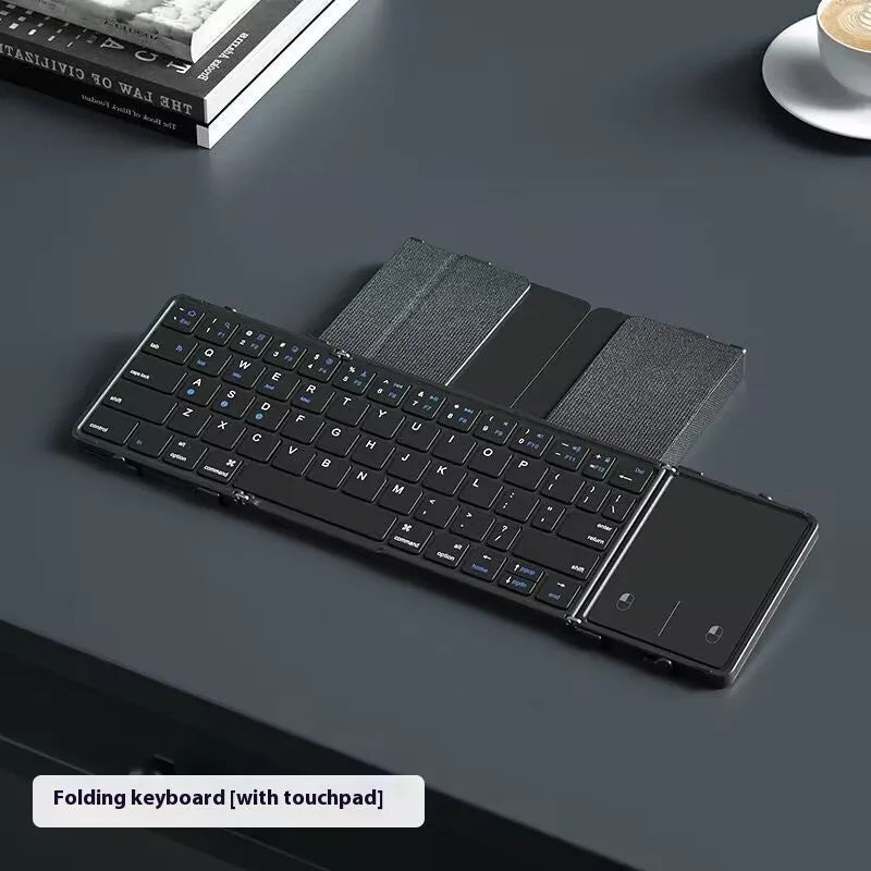 Black folding Bluetooth keyboard with touchpad unfolded showing full keyboard and touchpad surface