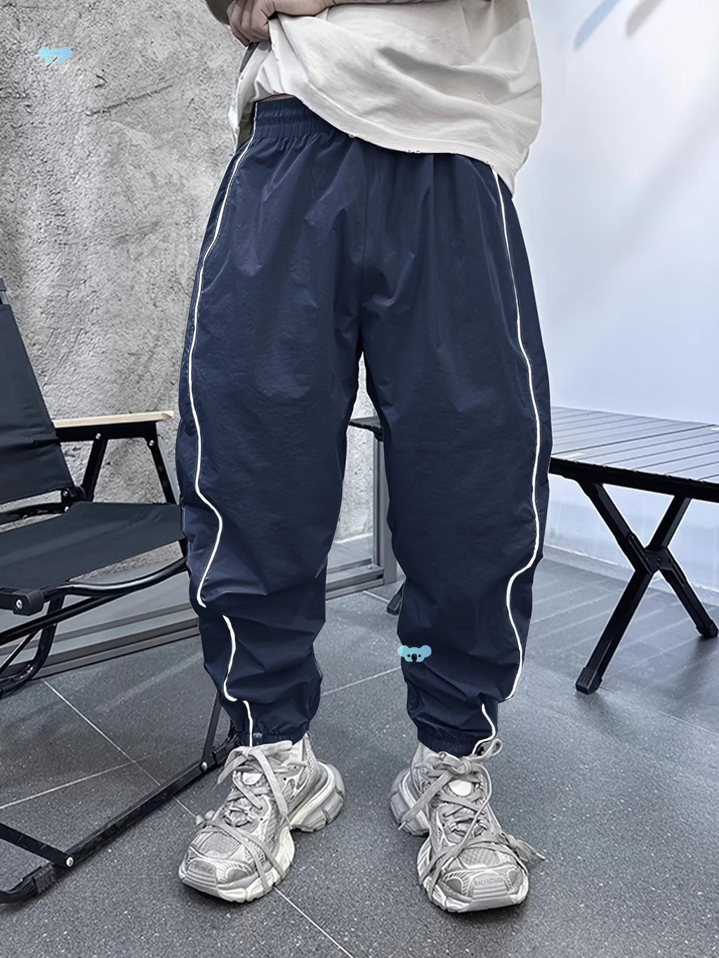 Man wearing blue bamboo fibre casual trousers with a cropped leg and loose fit.