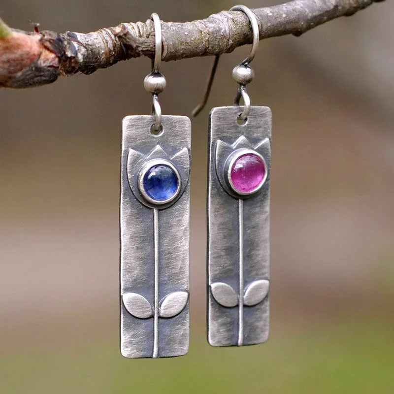 Red sapphire earrings with antique metal finish and geometric ellipse design