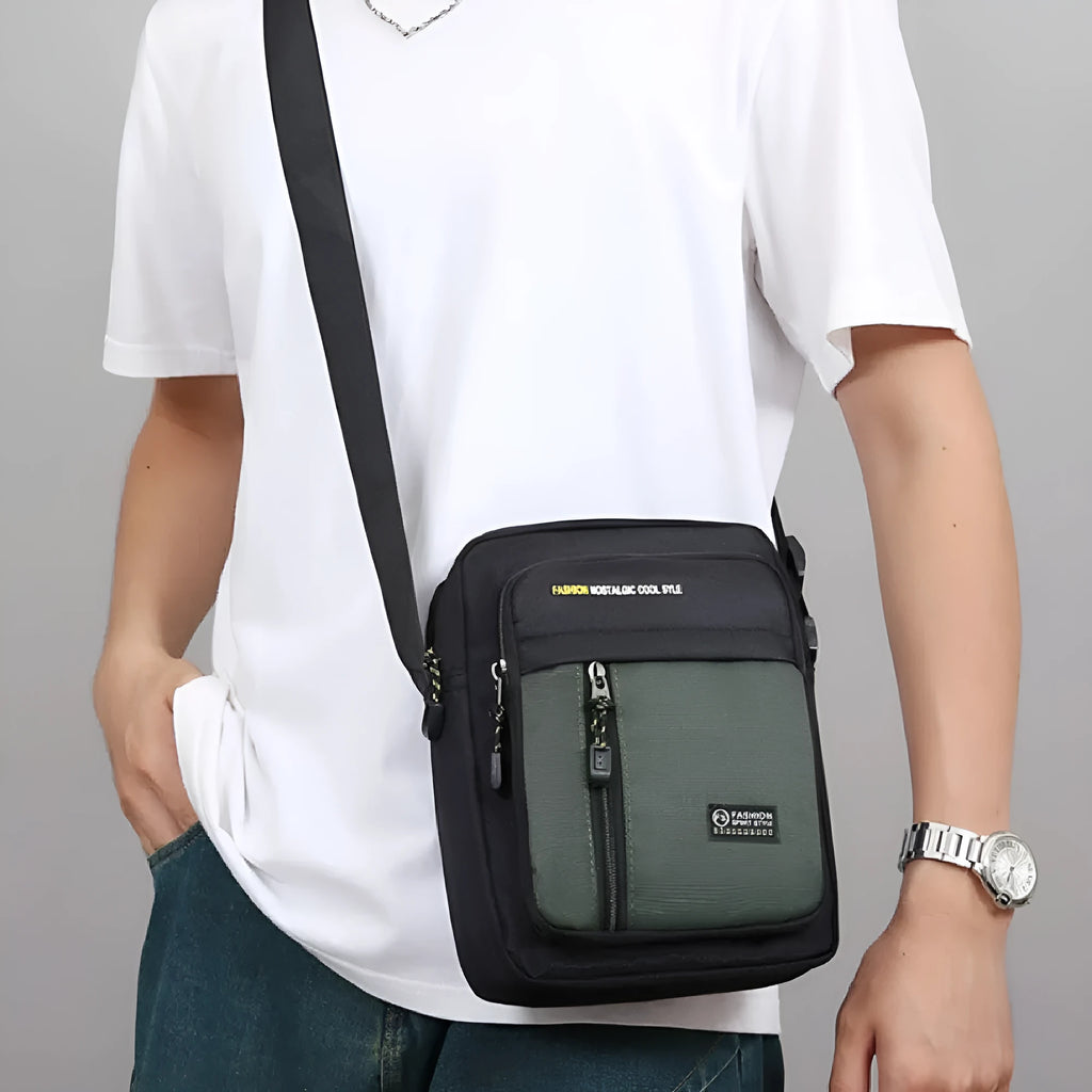 Men's nylon crossbody messenger bag with sewing thread detailing in black, blue, green, or grey.