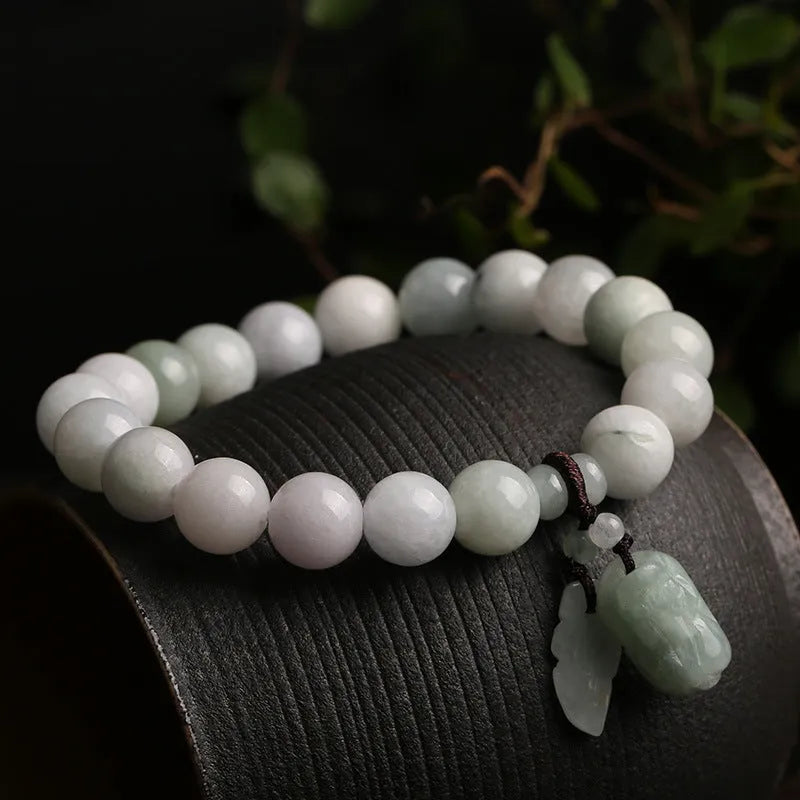 Natural emerald jade geometric bracelet with Maitreya Buddha, apple, and money bag hanging charms.