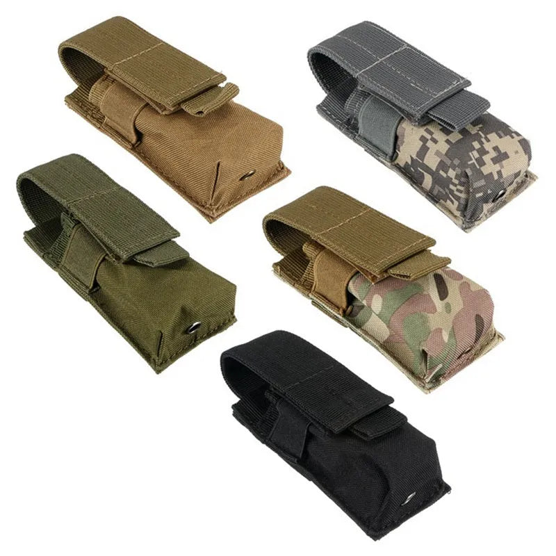 Black tactical MOLLE waist bag with elastic cord buckle, shown next to a small flashlight