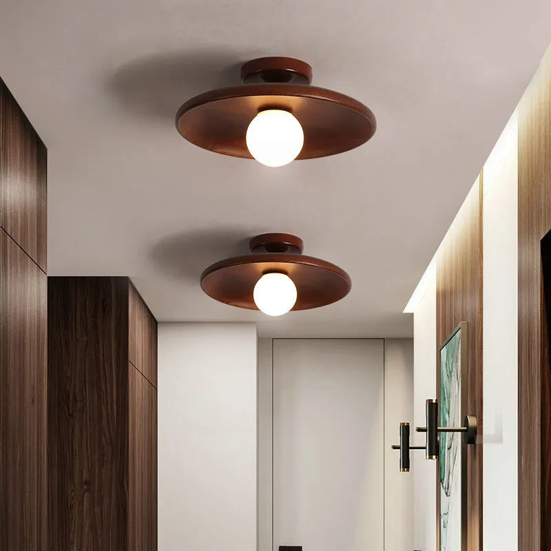 Minimalist solid wood and glass ceiling lamp in natural wood finish, 28cm diameter.