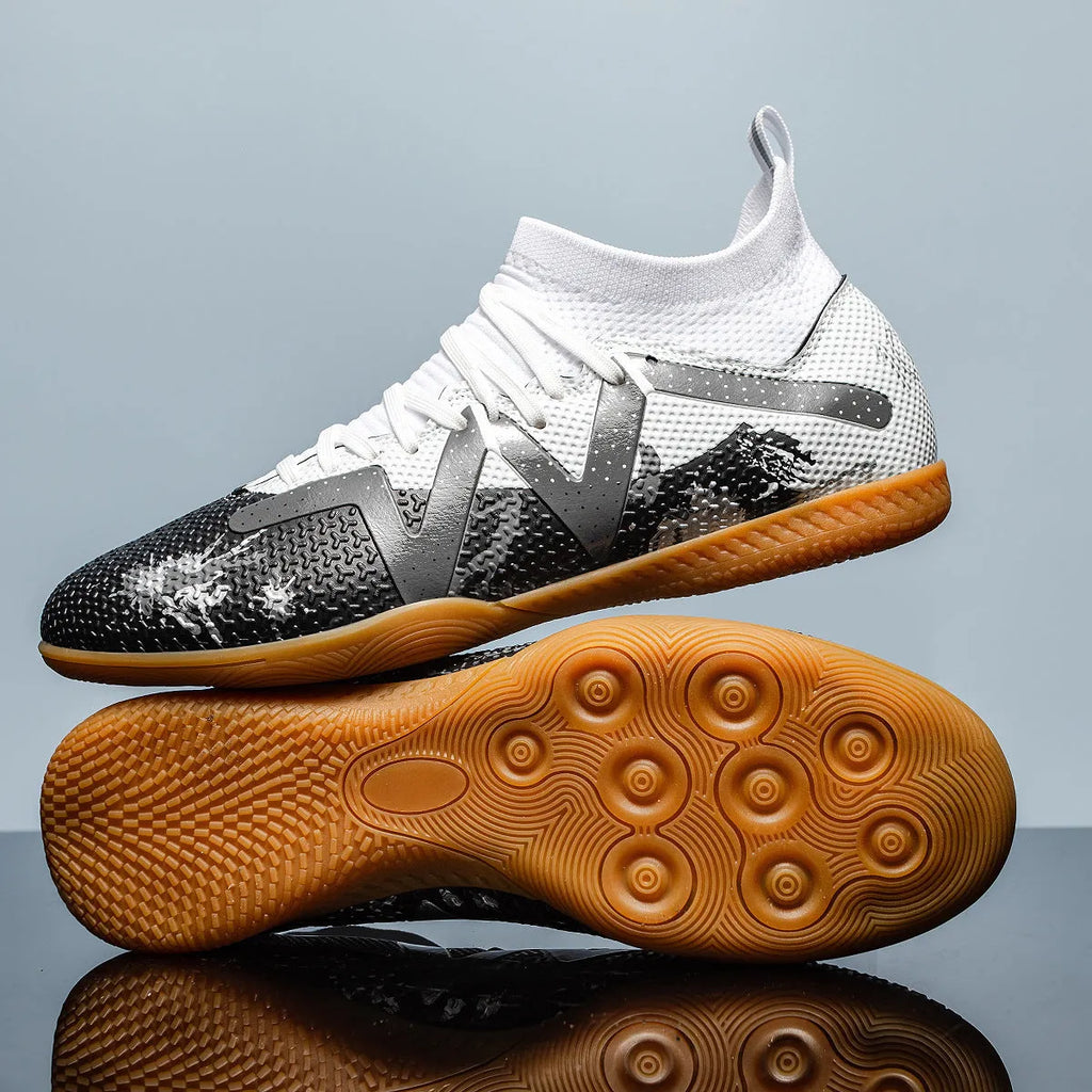Lining low-top football boots in black and yellow with spiked rubber sole, showing mesh and PVC upper construction.