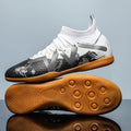 Lining low-top football boots in black and yellow with spiked rubber sole, showing mesh and PVC upper construction.