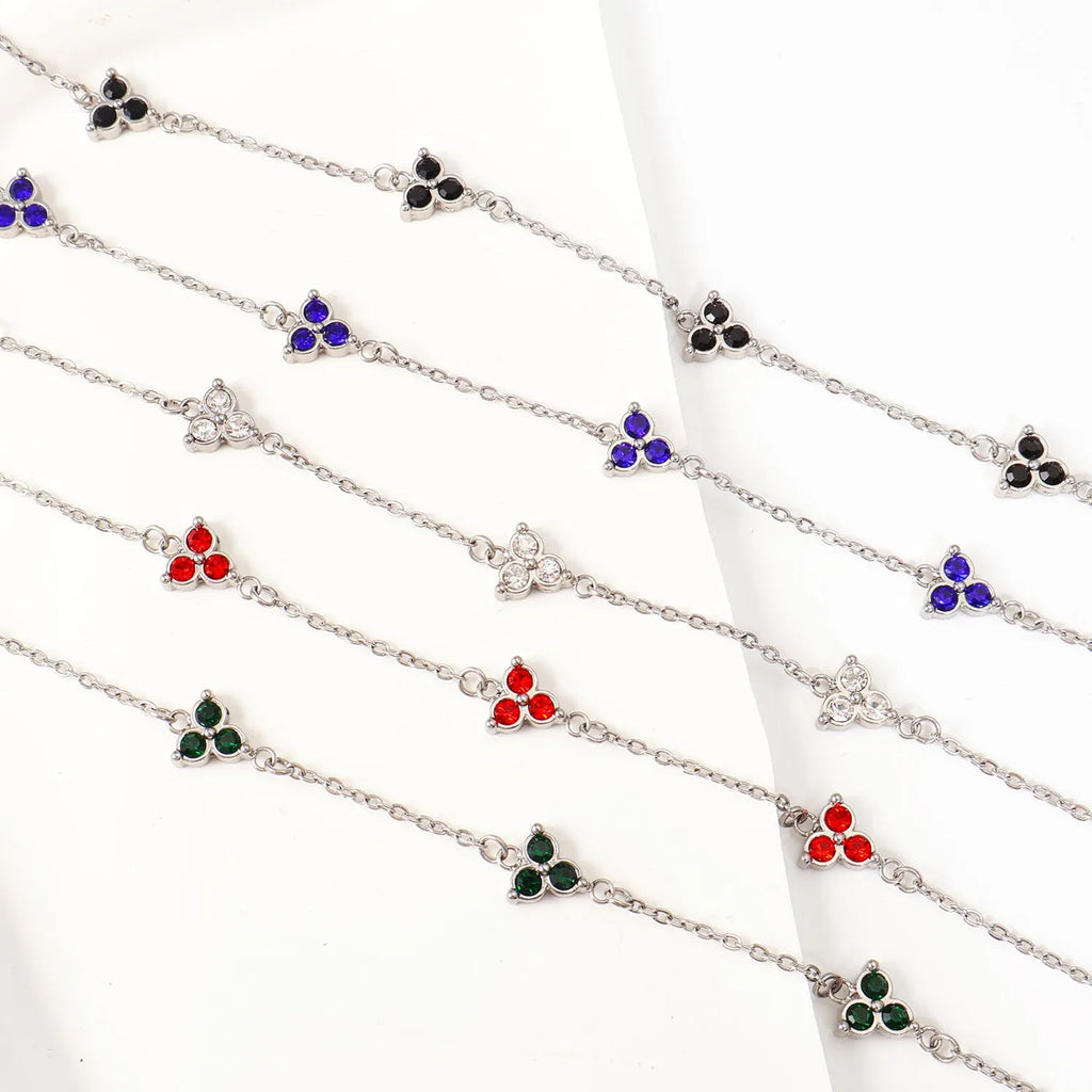 Women's stainless steel geometric triangle bracelet with a three-diamond pattern, shown in a gold and white zircon colour option.