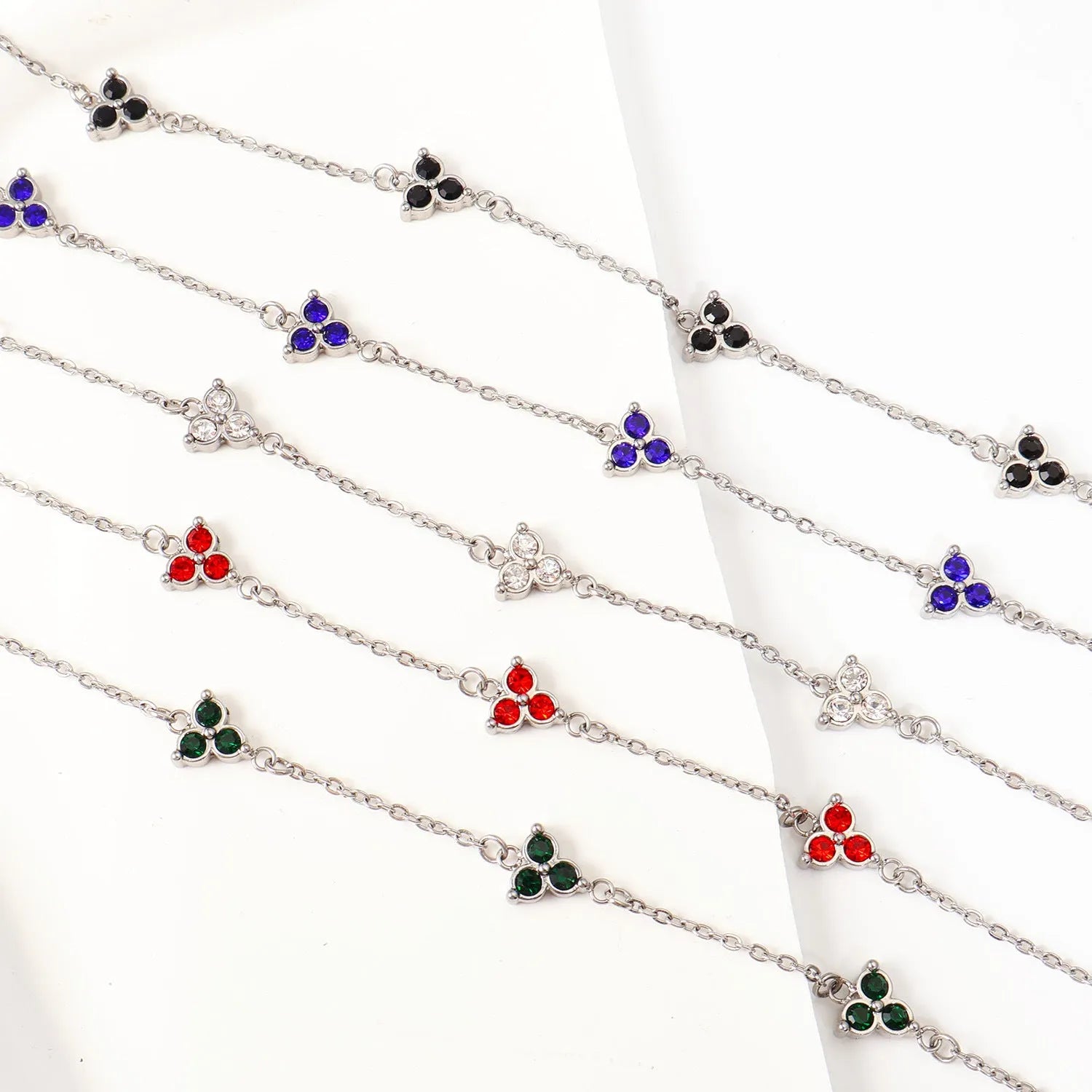 Women's stainless steel geometric triangle bracelet with a three-diamond pattern, shown in a gold and white zircon colour option.