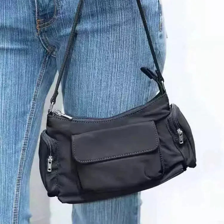 Simple black lightweight PU women's shoulder bag with double pockets and side line detail.