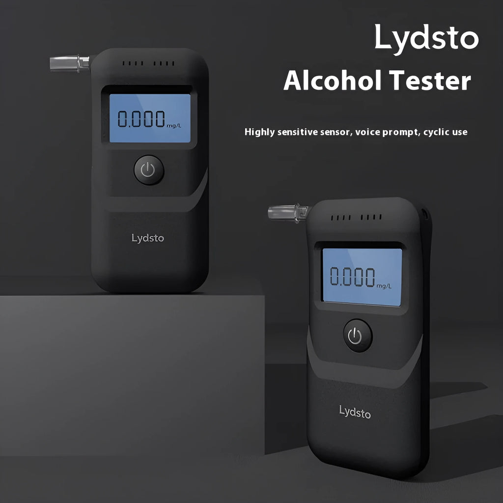 Black portable household alcohol breath tester with LCD screen on a dark background.