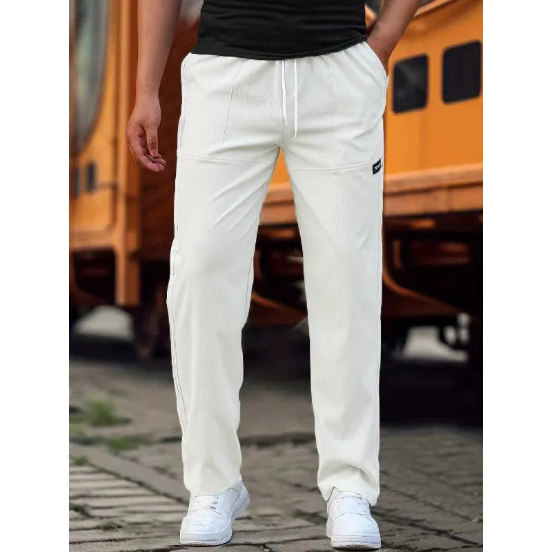 Men's light grey polyester trousers for spring and autumn casual wear, shown in Asian sizing.