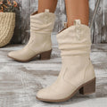 Women's mid-calf suede boots with chunky heel in lotus root colour on a plus size model.