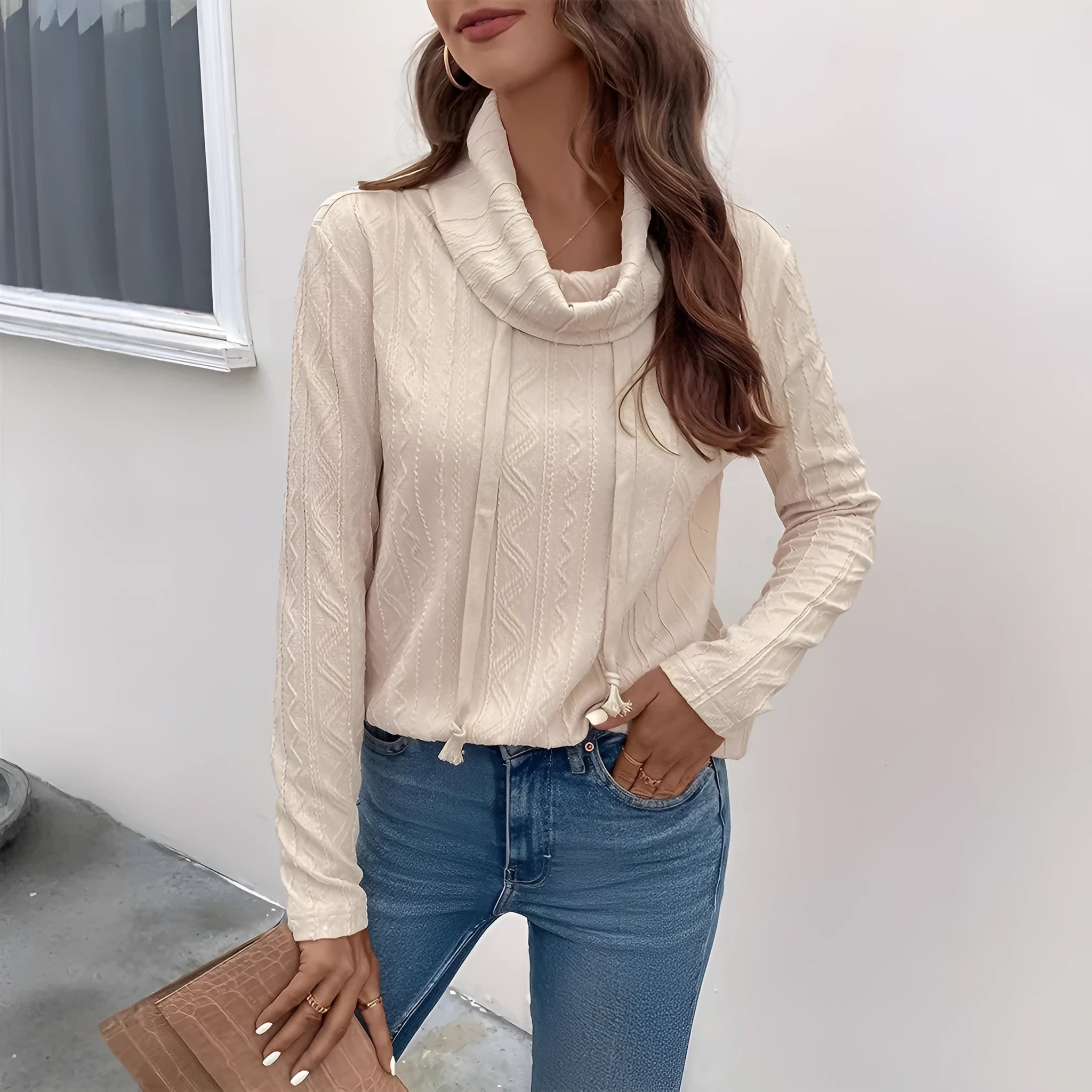 Apricot coloured long sleeve hooded pullover sweater with a drawstring, shown on a hanger.