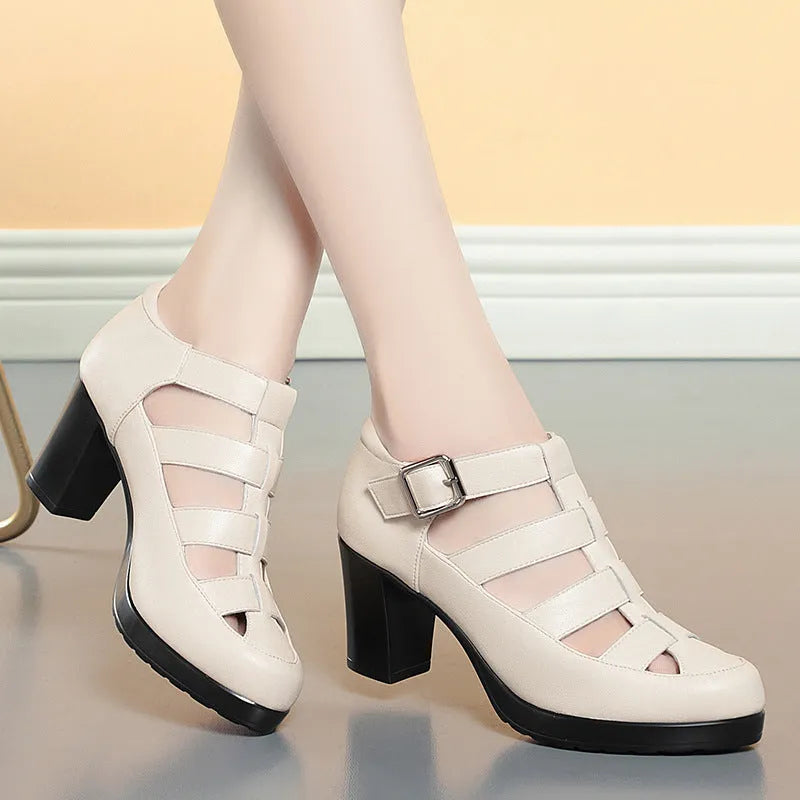 Women's beige closed toe sandals with a chunky heel, woven upper, ankle strap buckle, and back zipper.