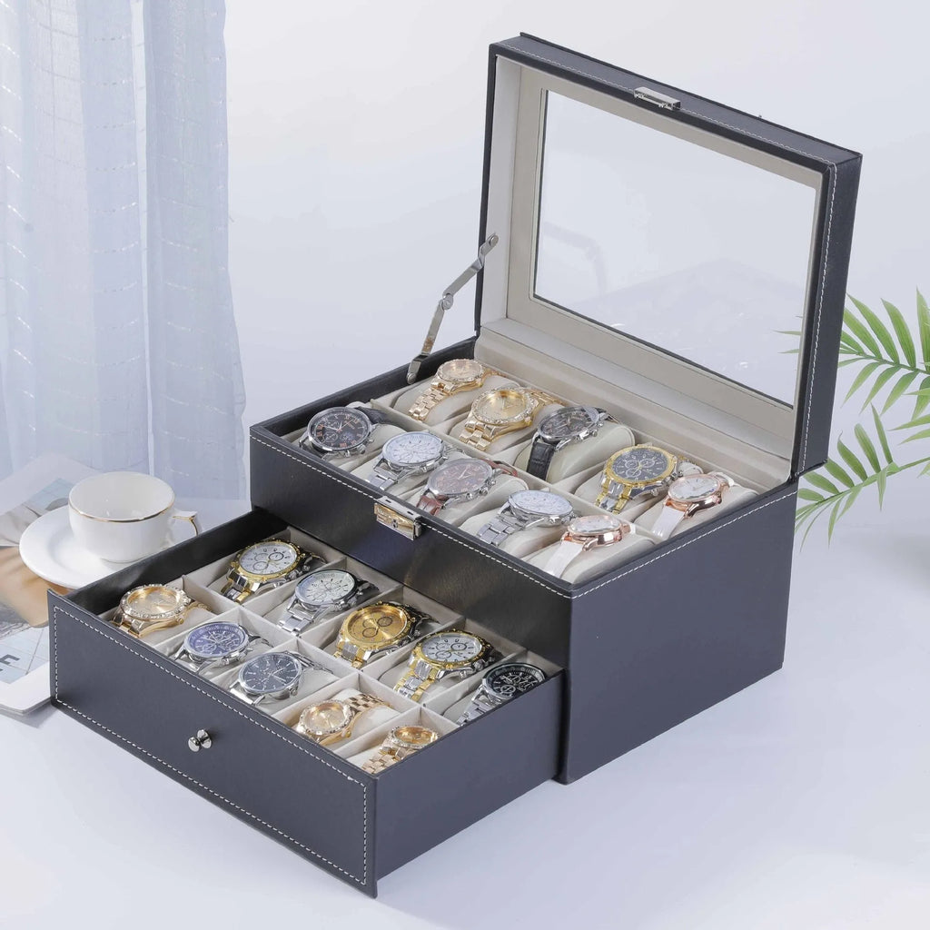 Grey leather watch storage box with transparent lid showing multiple watch slots inside