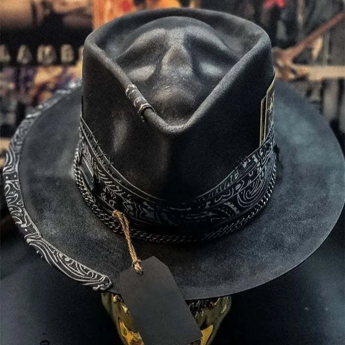 Handmade wool felt skull hat with a conical crown on a neutral background