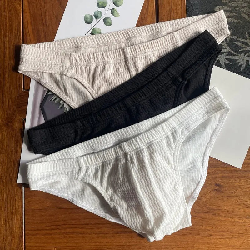 Men's solid colour cotton triangle underwear briefs with mid waistband, shown in apricot black colour.