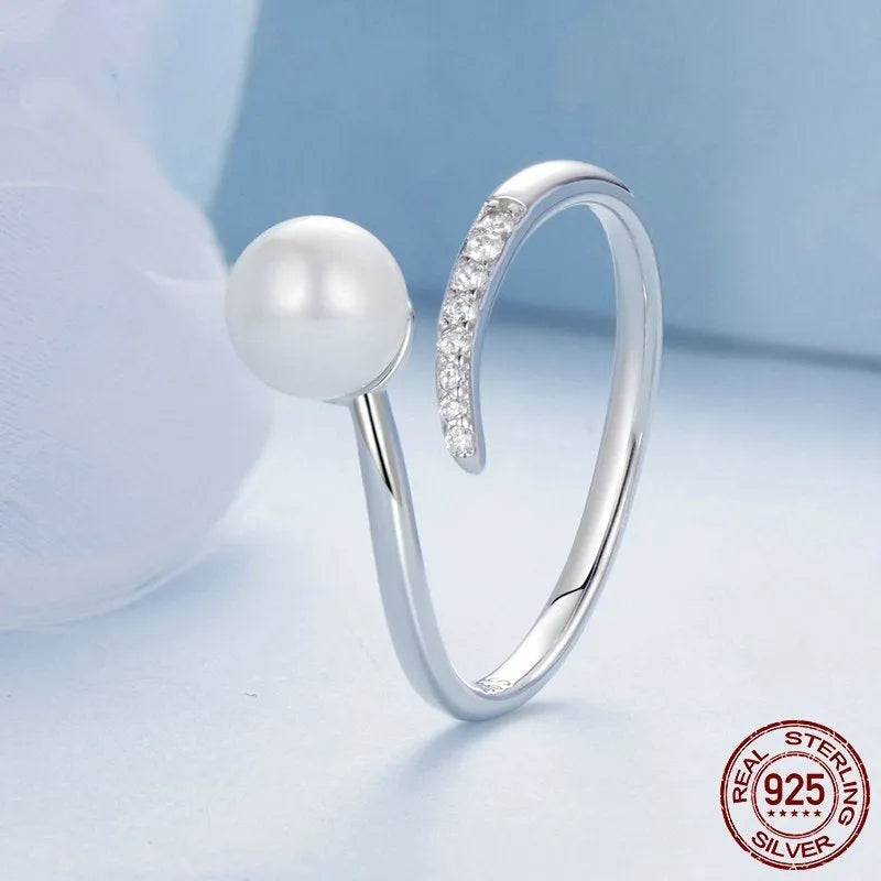 Women's adjustable sterling silver ring with natural pearl on open loop design