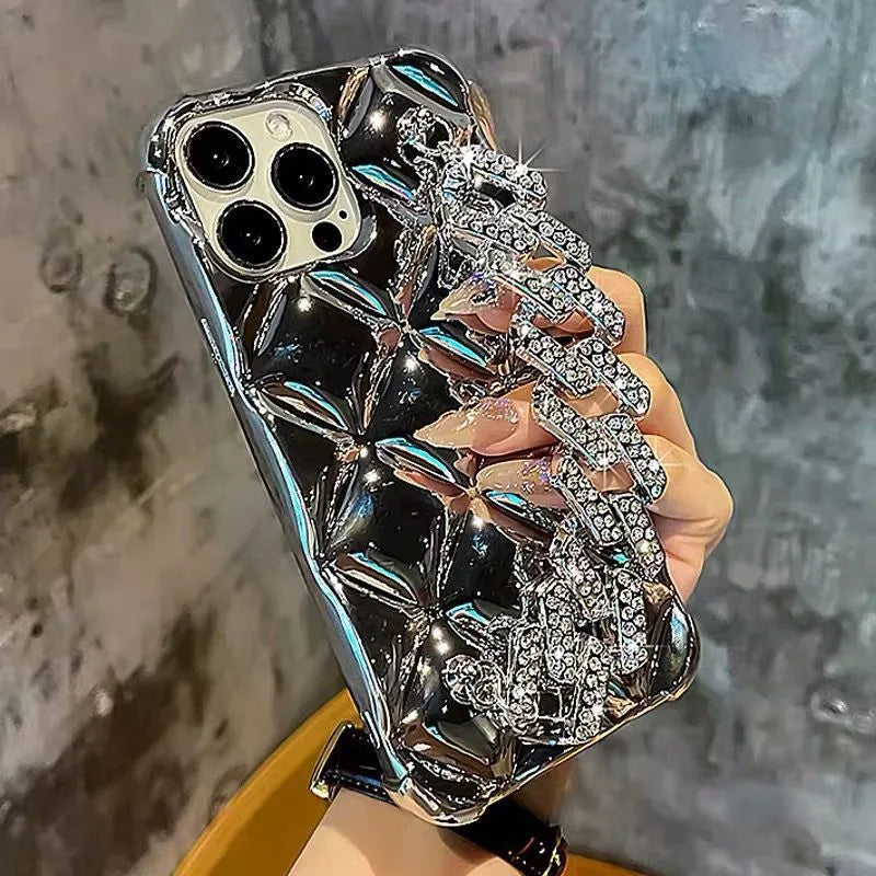 Gold diamond bracelet attached by chain to a TPU phone case for iPhone.