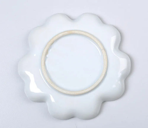 White ceramic plum blossom shaped artist's palette for paint mixing