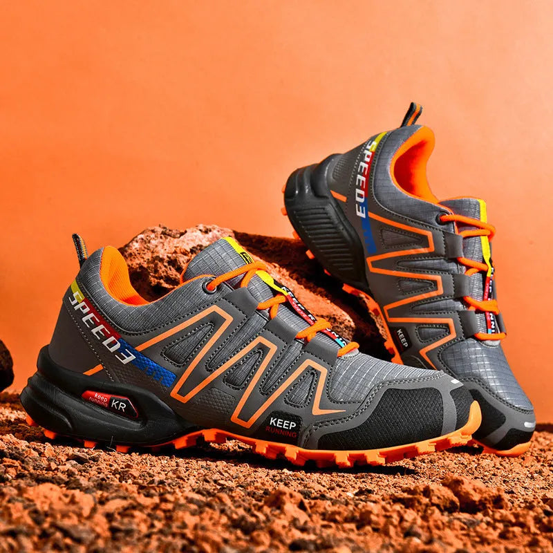 Men's low-top casual running shoe in synthetic leather with mesh lining, shown in grey orange colourway.