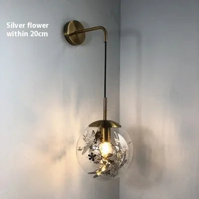 Modern glass wall lamp in golden flower or silver flower finish, shown in 15cm and 20cm sizes