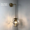 Modern glass wall lamp in golden flower or silver flower finish, shown in 15cm and 20cm sizes