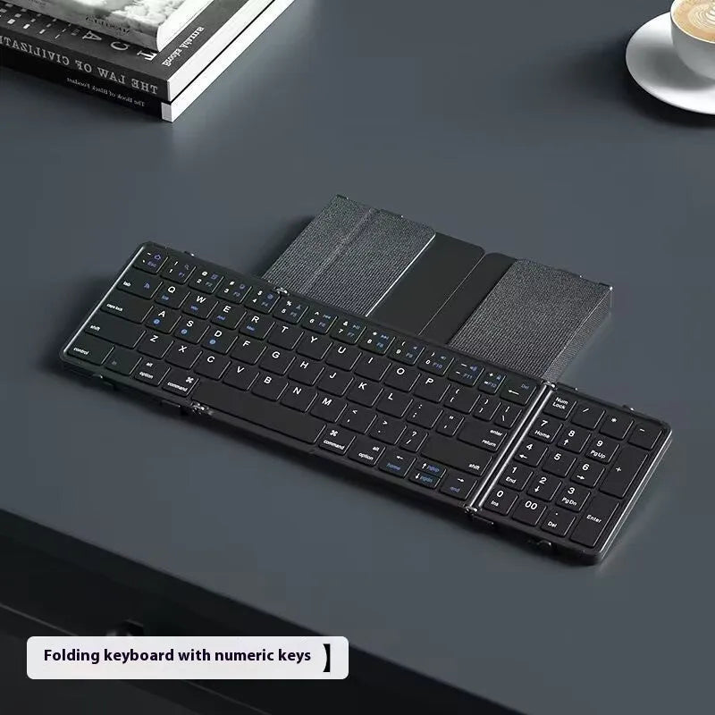 Black folding Bluetooth keyboard with touchpad unfolded showing full keyboard and touchpad surface