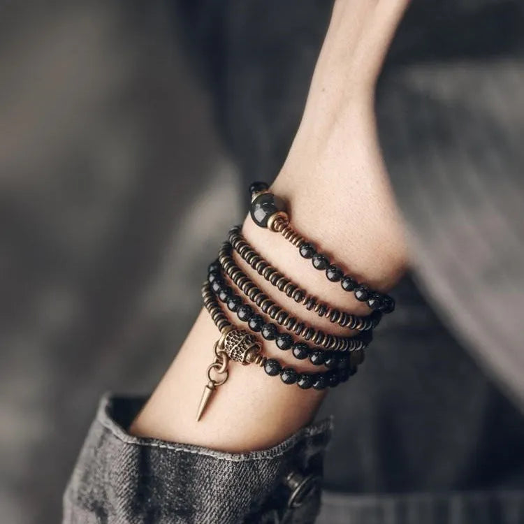 Black geometric beaded bracelet with colourful layered retro design.