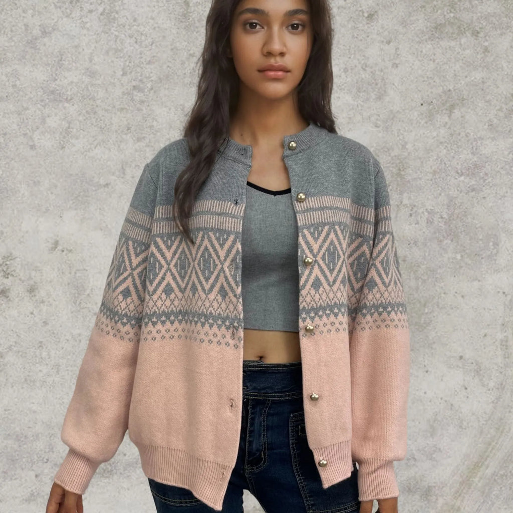 Woman wearing a grey alpaca wool cardigan with a long sleeve diamond pattern in a contrast colour.