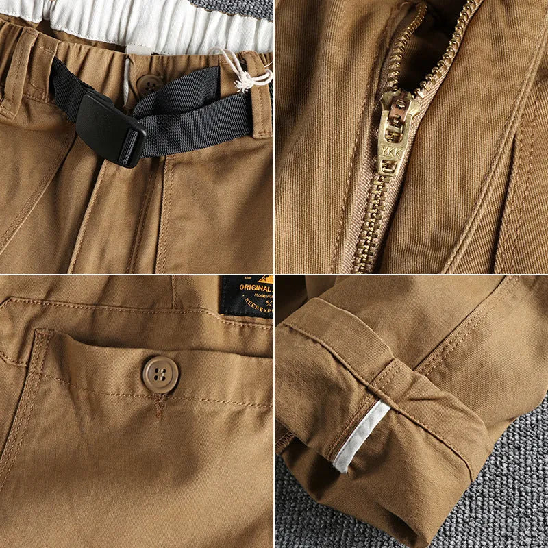 Men's khaki work trousers with a buckle belt and three-dimensional cutting on a hanger.
