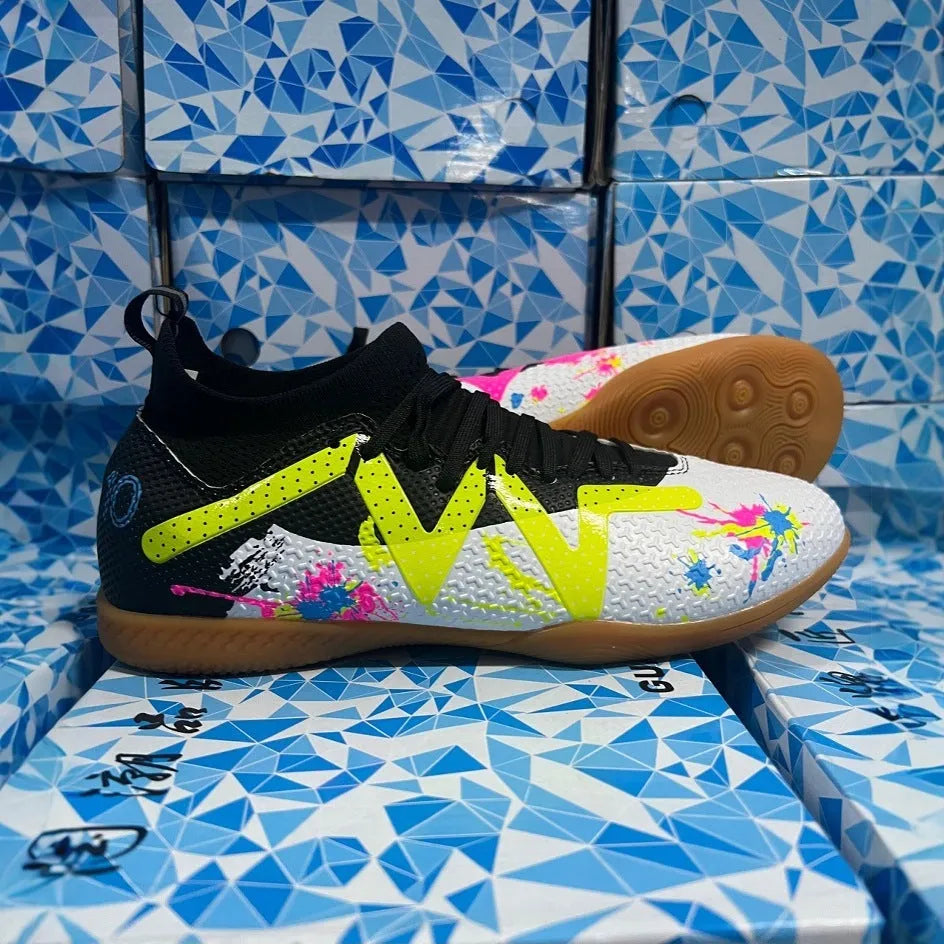 Lining low-top football boots in black and yellow with spiked rubber sole, showing mesh and PVC upper construction.