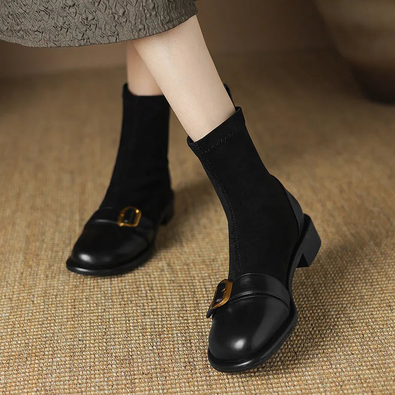 Women's black casual Martin ankle boots with lace-up front and buckle stitching detail on a low heel.