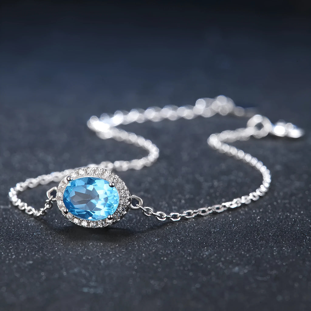 Geometric design 925 sterling silver jewellery set with blue topaz, showing earrings, ring, pendant and necklace.