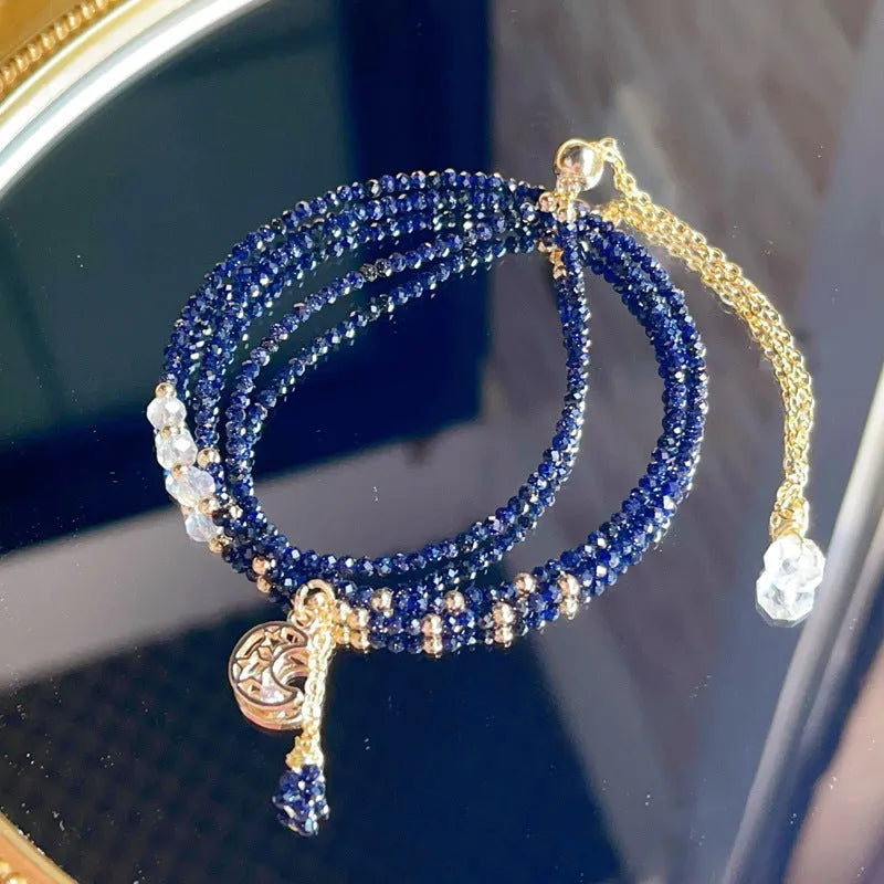 Handmade multi-layer women's bracelet in blue sand colour with three rings and stone-cut beads.