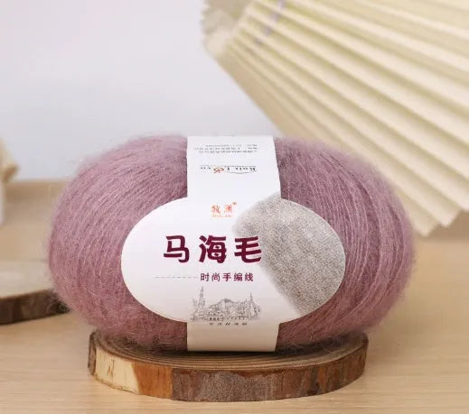 Single ball of mohair yarn in various colours for hand-woven DIY scarf knitting projects