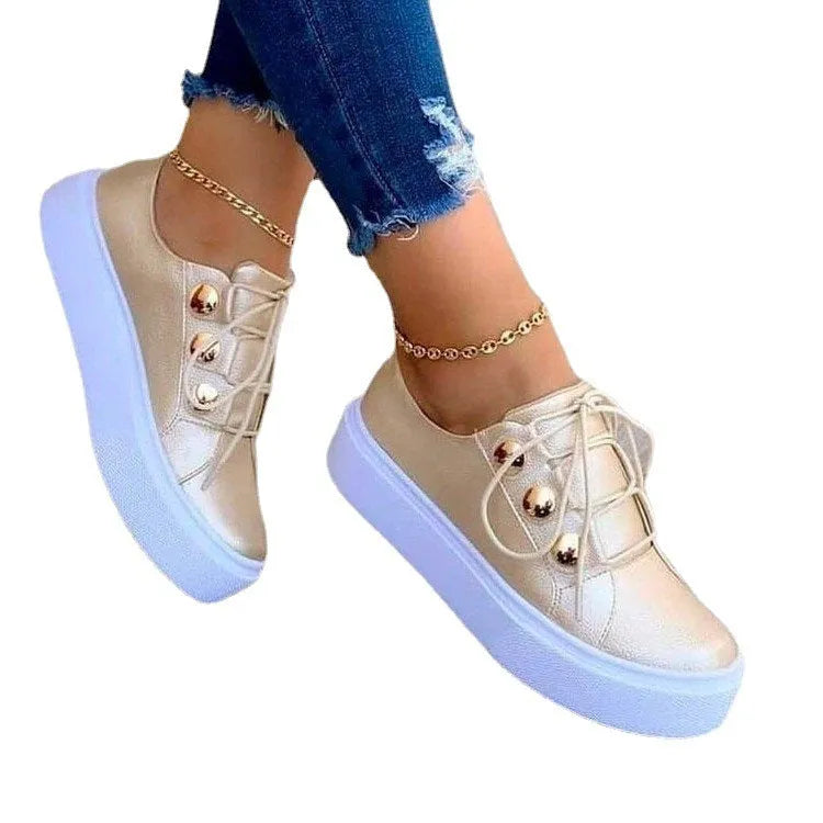 Women's lace-up flats sneakers with rivet detail, artificial PU upper, round toe, and polyurethane sole in white, black, gold, or rose gold.
