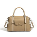 Genuine leather ladies handbag in black, brown, or elephant grey with contrast stitching and a lock.