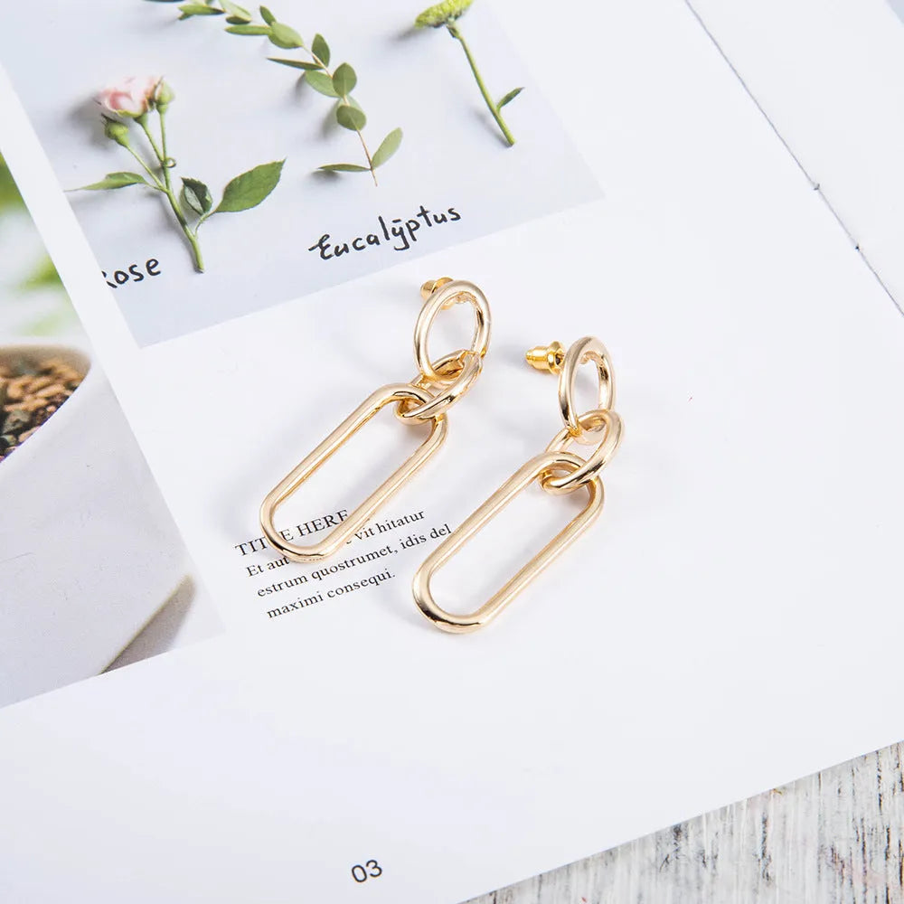 Sterling silver needle coloured geometric hoop earrings for women with ring and line design.