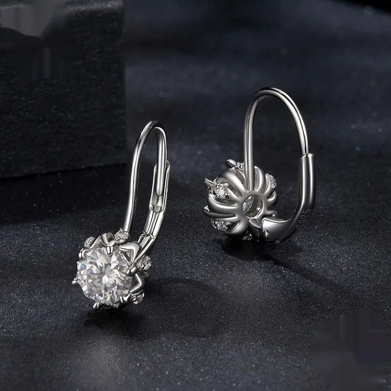 White gold plated sterling silver flower bud ear clip with a moissanite stone.